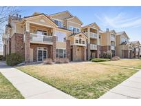 Attractive condo building featuring brick accents, private balconies, and well-maintained landscaping at 5763 N Gibralter Way # 2-108, Aurora, CO 80019