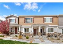 Inviting townhome featuring charming exteriors, landscaped front yard, and private entrances at 871 E 98Th Ave # 1402, Thornton, CO 80229