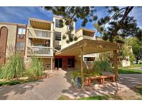 Inviting condo building with well-maintained landscaping and covered entrance at 1300 S Parker Rd # 212, Denver, CO 80231
