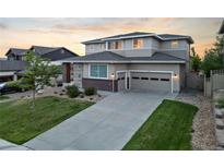 Beautiful two-story home with a well-manicured lawn, charming curb appeal, and a two car garage at 4145 Manorbrier Cir, Castle Rock, CO 80104
