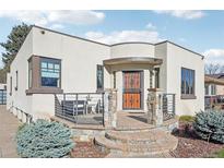 Charming home featuring a covered front porch with stone accents and outdoor seating at 621 Kearney St, Denver, CO 80220