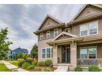 Inviting exterior of a two-story home featuring a covered porch and lush landscaping at 5975 Hanover St, Denver, CO 80238