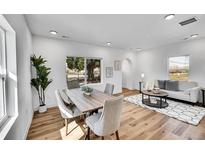 Bright dining room features a wooden table set and view to outside at 16130 Mt Vernon Rd, Golden, CO 80401