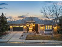 Charming single-story home boasting stone accents, gray roof, and a two-car garage at 2988 Rockbridge Dr, Highlands Ranch, CO 80129