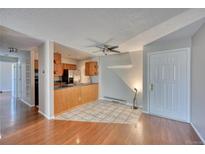 Inviting living room featuring an open kitchen, and stylish tile flooring, ideal for modern living at 14780 E Kentucky Dr # 432, Aurora, CO 80012