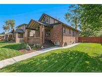 Charming brick home featuring a well-manicured lawn and inviting front porch at 2740 N Fillmore St, Denver, CO 80205