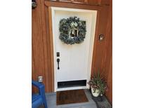 Inviting front door with festive wreath, keyless entry and decorative potted flowers at 21221 Colorado 103, Idaho Springs, CO 80452