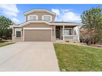 Charming two-story home with a two-car garage and inviting front porch at 1232 Berganot Trl, Castle Pines, CO 80108