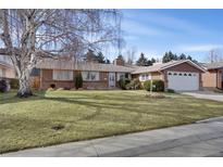 Charming single-story home boasts a well-maintained lawn, mature trees, and attached two-car garage at 2290 E Columbia Pl, Denver, CO 80210