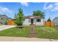 Charming single-story home with a well-maintained lawn, walkway, and a partially fenced yard at 118 S Yates Way, Denver, CO 80219