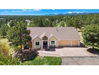 Charming single-Gathering home featuring a spacious three-car garage and front seating area at 19050 Archers Dr, Monument, CO 80132