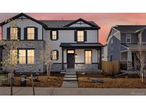 Charming two-story home featuring stone accents, and a well-maintained front yard, perfect for curb appeal at 22435 E 7Th Pl, Aurora, CO 80018