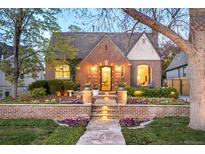 Charming brick home with landscaped front yard and inviting stone pathway, showcasing classic curb appeal at 628 Cherry St, Denver, CO 80220