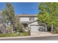 Charming two-story home with a well-maintained front yard and attached two-car garage at 5316 S Rome St, Aurora, CO 80015