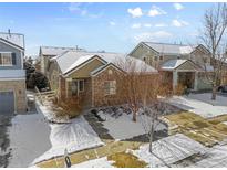 Charming single-Gathering home with a brick facade, snow-covered roof, and well-maintained landscaping at 24726 E Louisiana Cir, Aurora, CO 80018