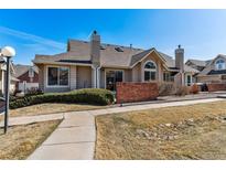 Charming single-story home featuring a well-manicured lawn and welcoming walkway on a bright, sunny day at 2135 S Troy Way, Aurora, CO 80014