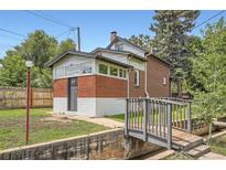 Quaint brick home featuring charming architectural details and a small bridge leading to the entrance at 3655 Zenobia St, Denver, CO 80212