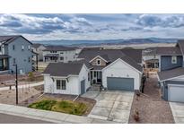 Beautiful single Gathering home with a two-car garage, nicely manicured yard, and mountain views at 4797 Saddle Iron Rd, Castle Rock, CO 80104