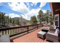 Inviting deck with mountain views, wicker seating, and a fire pit offers a relaxing outdoor space at 72 Rudi W Ln, Golden, CO 80403