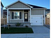 Charming single-story home featuring a well-manicured lawn and an attached two-car garage, enhancing curb appeal at 857 Sawdust Dr, Brighton, CO 80601