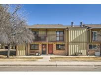 Two-story townhome featuring balconies, brick accents, and a well-kept front yard at 492 Vance St, Lakewood, CO 80226