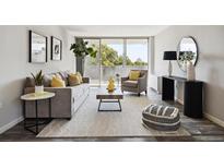 Bright living room with stylish decor, large windows, and a cozy seating area perfect for relaxation at 909 N Logan St # 6K, Denver, CO 80203