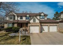 Charming two-story home with brick accents and a three car garage at 17085 E Dorado Cir, Centennial, CO 80015