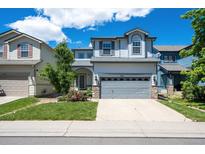 Charming two-story home featuring a well-maintained front yard and a spacious two-car garage at 5193 E 119Th Way, Thornton, CO 80233