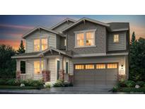 Charming two-story home with stone accents, a covered porch, well-manicured landscaping, and an attached two-car garage at 4592 Windmill Dr, Brighton, CO 80601