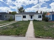 Charming single-story home featuring a well-maintained front yard and attached one car garage at 1237 Tamarac St, Denver, CO 80220