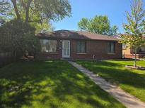 Charming brick home with a well-manicured lawn and mature trees in a desirable neighborhood at 2285 Ironton St, Aurora, CO 80010