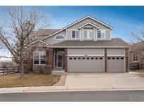 Charming two-story home with a three-car garage and a combination of siding and brick accents at 7506 Chipmunk Pl, Littleton, CO 80125