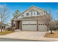Charming two-story home with a three-car garage and a well-manicured front yard at 7506 Chipmunk Pl, Littleton, CO 80125
