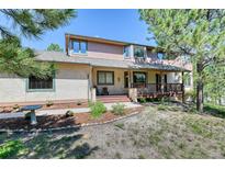 Charming two-story home with a covered front porch and well-maintained landscaping at 20380 Silver Horn Ln, Monument, CO 80132
