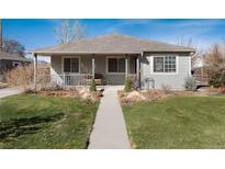 Charming single story home featuring a covered porch and landscaped front yard at 2307 Moline St, Aurora, CO 80010