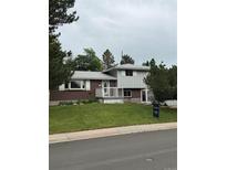 Charming two-story home with brick and siding, features a well-manicured lawn and inviting curb appeal at 3566 E Fair Pl, Centennial, CO 80121