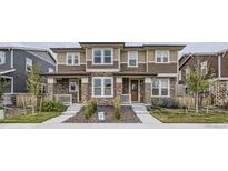 Attractive home exterior with stone accents, neutral siding, and a well-maintained lawn at 6233 N Liverpool St, Aurora, CO 80019