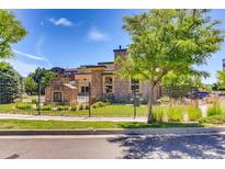 Attractive exterior featuring well-maintained landscaping, a wrought-iron fence, and a modern building design at 13456 Via Varra # 315, Broomfield, CO 80020