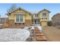 Inviting home exterior featuring stone accents, well-maintained landscaping, and a two-car garage at 8385 Briar Trace Dr, Castle Pines, CO 80108