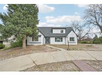 Charming single-Gathering home with a white brick exterior and a gray roof at 796 S Bristol St, Lakewood, CO 80228