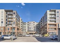 Modern apartment building with a combination of brick and siding and multiple balconies at 20 Wilcox St # 308, Castle Rock, CO 80104