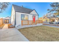 House exterior with a red door and well-maintained lawn at 141 S Knox Ct, Denver, CO 80219