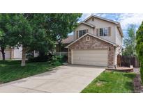 Charming two-story home with a brick facade and well-maintained front yard at 4164 E 135Th Pl, Thornton, CO 80241