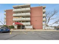 Exterior building view showcasing the entrance, balconies, and the building's brick facade at 4600 E Asbury Cir # 210, Denver, CO 80222