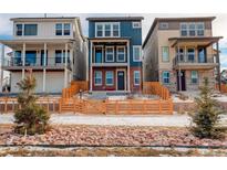 Charming two-story home with a blue facade, brick accents, and a lovely wooden fence at 11063 Shining Star Cir, Parker, CO 80134