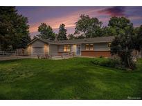 Charming ranch home with a lush green lawn, mature trees, and a freshly painted exterior at 3272 S Joplin Ct, Aurora, CO 80013
