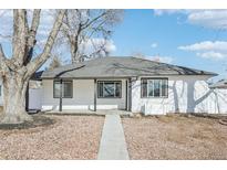 Charming single-story home with white siding, black trim, and a well-maintained front yard at 1857 W Tennessee Ave, Denver, CO 80223