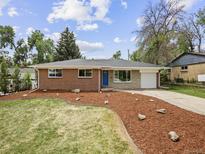 Charming single-story brick home with a well-maintained lawn and inviting blue front door at 9120 W 3Rd Pl, Lakewood, CO 80226