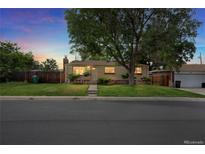 Charming single-story home featuring a well-manicured front yard and a large tree at 8881 Judson St, Westminster, CO 80031