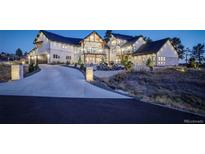 Beautiful two-story home featuring a circular driveway, stone accents, manicured landscaping, and a welcoming entrance at 13176 Frannys Way, Parker, CO 80138